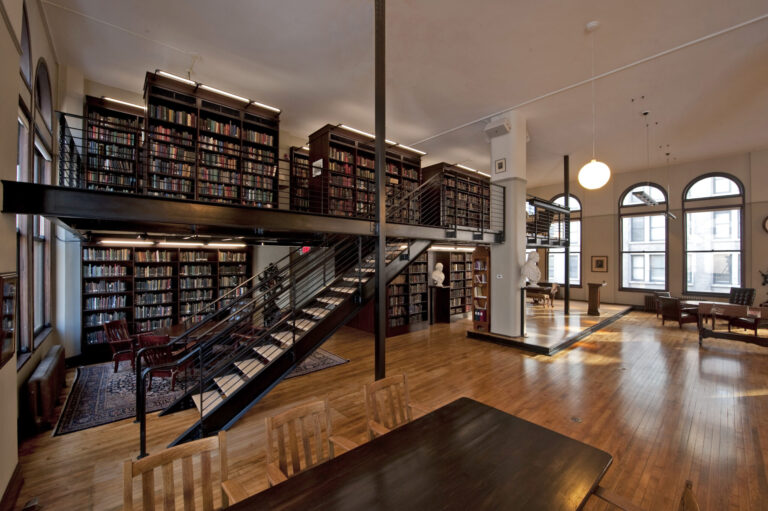 Picture from the inside of the Mercantile Library with dark wood shelves and staircases.